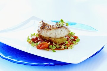 Fried red snapper on grilled potato, cherry tomatoes