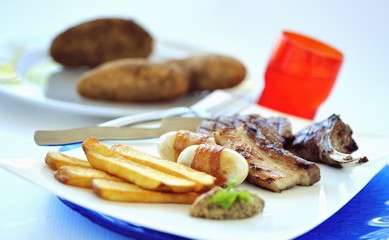 Grilled bacon, lamb chops and potatoes