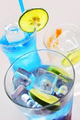 Three soda water drinks with lime on ice