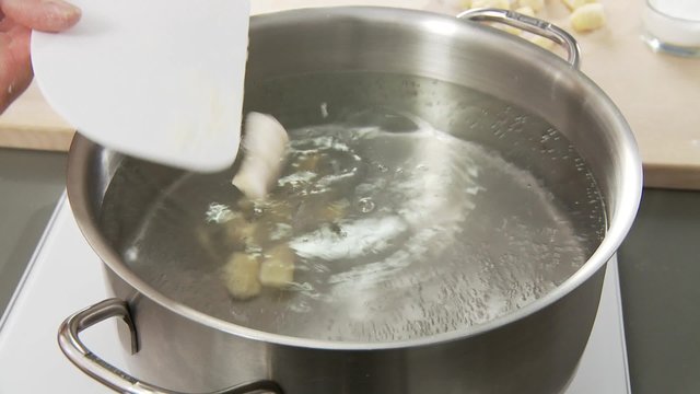Gnocci being added to salt water