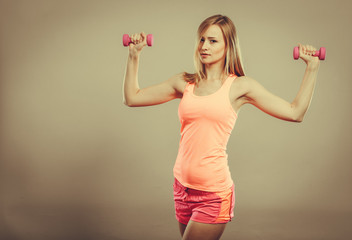 Fitness woman exercising with dumbbells.