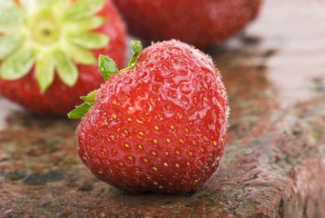 Strawberries on wet brick