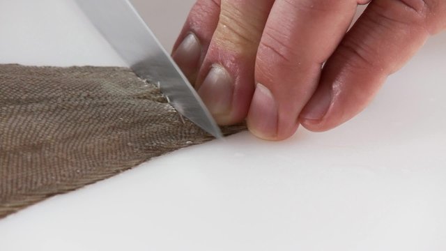 Sole being prepared - slitting the skin on the tail