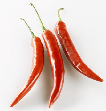 Three shiny red chillies © superfood