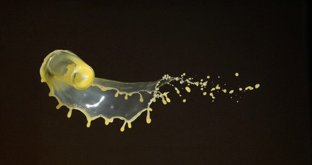 Orange juice splashing out of falling glass