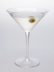 Martini with green olive in glass