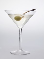Martini with green olive in glass