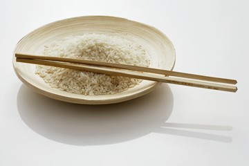 A plate of rice with chopsticks