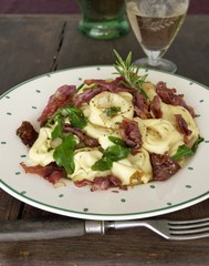 Tortellini with mushroom filling, rocket and crispy bacon