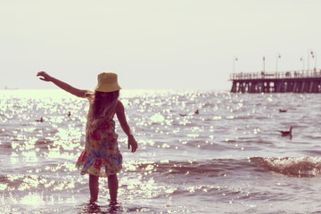 Little girl kid walking on beach at sea. Fun.