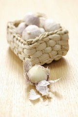 Small basket of Asian garlic, one bulb partly peeled