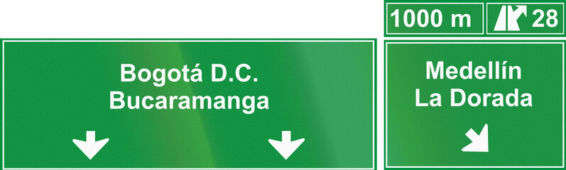 A directional road sign in Colombia, located above highway lanes