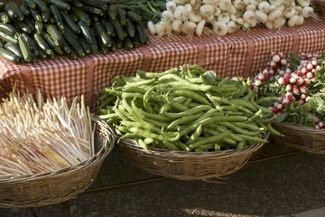 Vegetables on stall and in baskets at a market