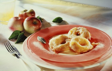 Three apple fritters with custard