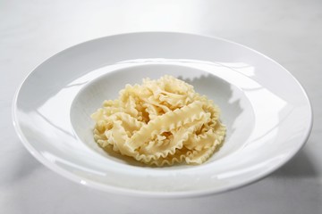 Cooked mafaldine in a pasta plate