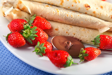 Pancakes with chocolate and strawberries