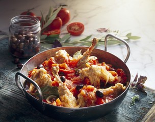 Braised guinea fowl in a tomato and pepper medley