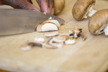 Fototapeta na wymiar Black Man Chopping Mushrooms