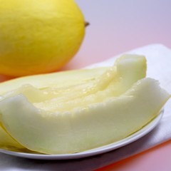Whole honeydew melon and slices of melon
