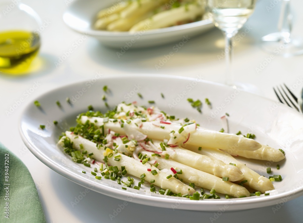 Wall mural asparagus with radish and egg vinaigrette on a platter