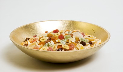 Dried fruit and nuts in golden dish