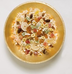 Dried fruit and nuts in golden dish