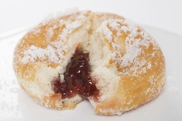 A sugared doughnut filled with jam