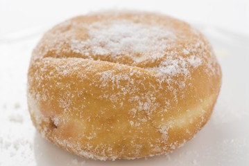 A sugared doughnut filled with jam