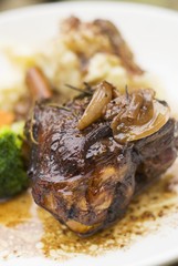Braised lamb shank on mashed potatoes and vegetables