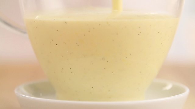 Vanilla sauce being poured into a sauciere