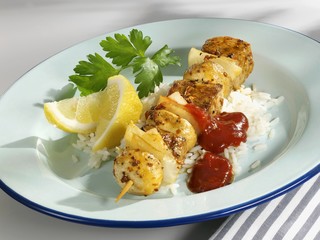 Fried veal and mushroom kebab on rice