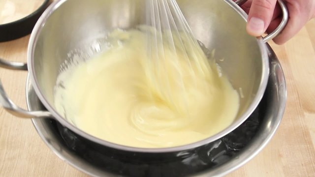 Egg cream being stirred over a bain marie