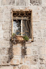 window with plant in a stone wall