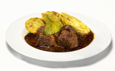 Hungarian goulash with napkin dumplings and gherkins