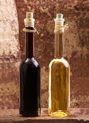 Oil and vinegar bottles on brick