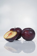 Plums, whole and halved