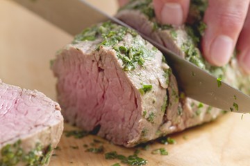 Steamed veal fillet being sliced