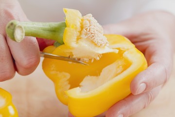 The stalk being removed from a pepper