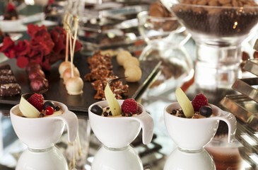 Pralines and coffee desserts in cups in a confectioner's shop