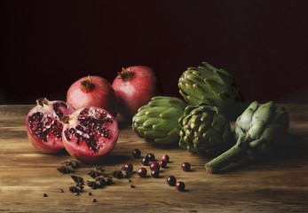 An arrangement of pomegranates and artichokes