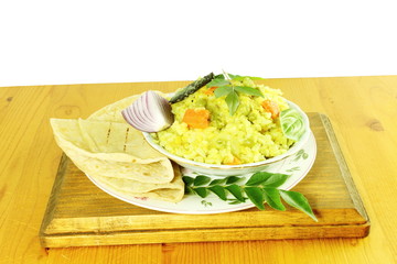 indian vegetable rice -khichdi with tortilla bread roti or naan