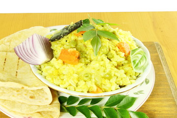 indian vegetable rice -khichdi with tortilla bread roti or naan