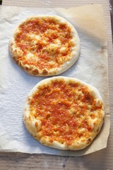 Two pizzas with tomatoes