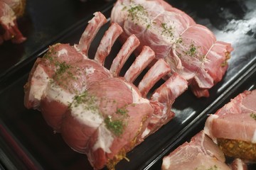 Uncooked, Prepared Pork Roasts in Display Case at a Market