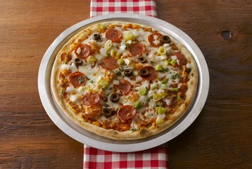 Salami pizza in a baking tin