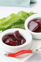 Two Small Bowls of Pickled Beets; Red Spoon