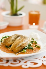 Tilapia fillet on pepper sauce with cresss