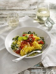 Saffron risotto on a bed of leek with braised tomatoes