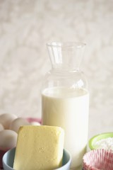 Butter, milk and eggs (ingredients for making cupcakes)