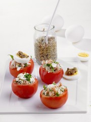 Tomatoes stuffed with prawns, sauerkraut, egg and mastered